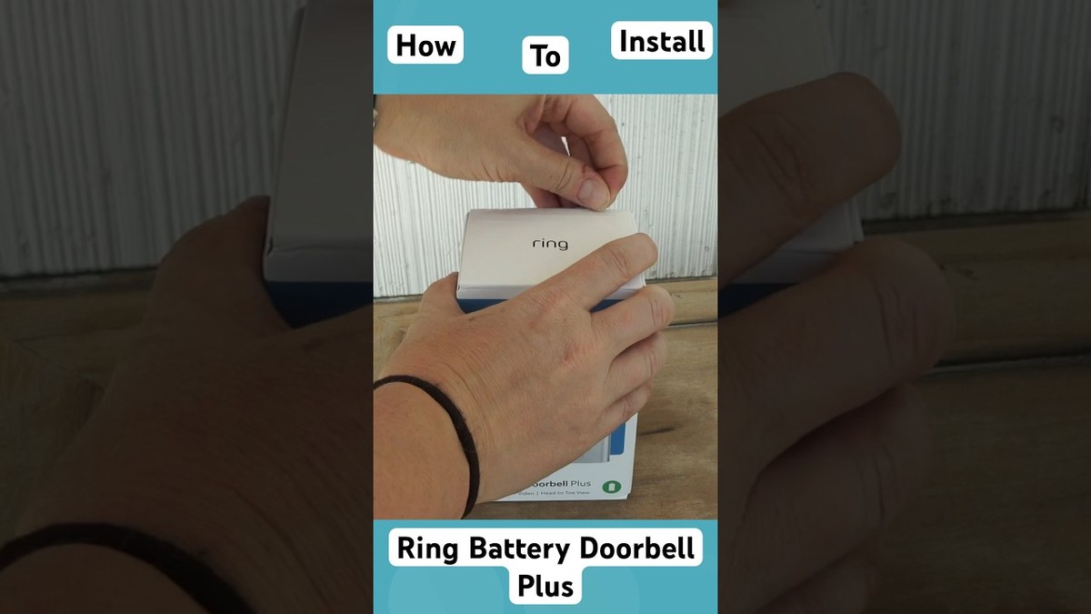 Person installing a Ring Battery Doorbell Plus on a front door with tools nearby