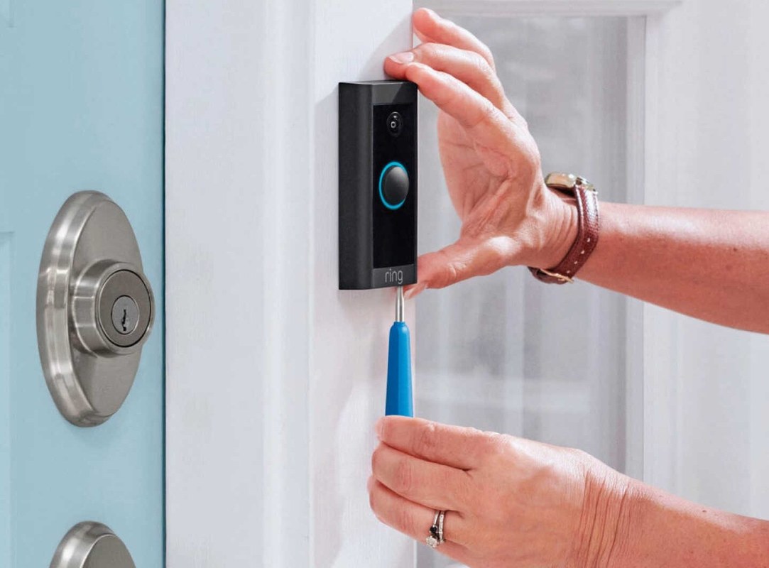 Smart home security setup showing a video doorbell mounted on an apartment door