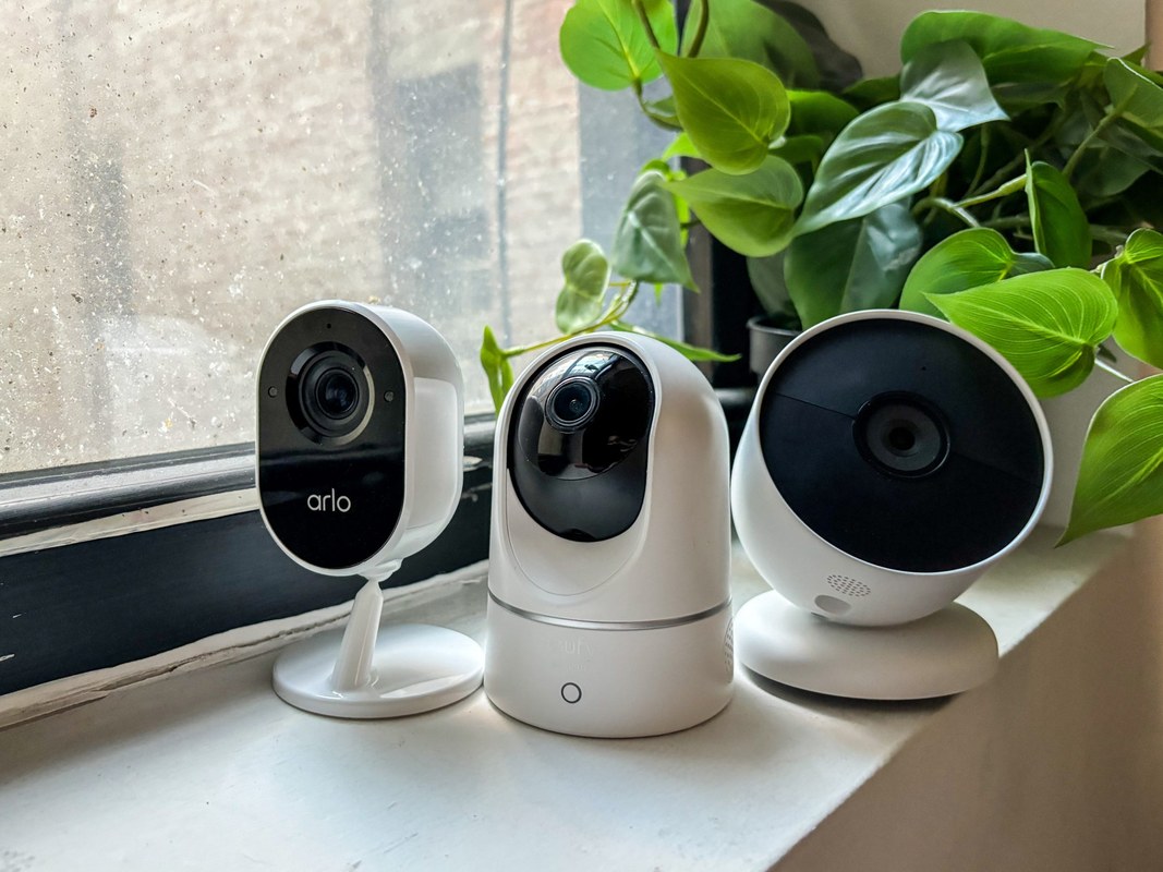 Indoor security camera on a dresser facing a bed in a private bedroom